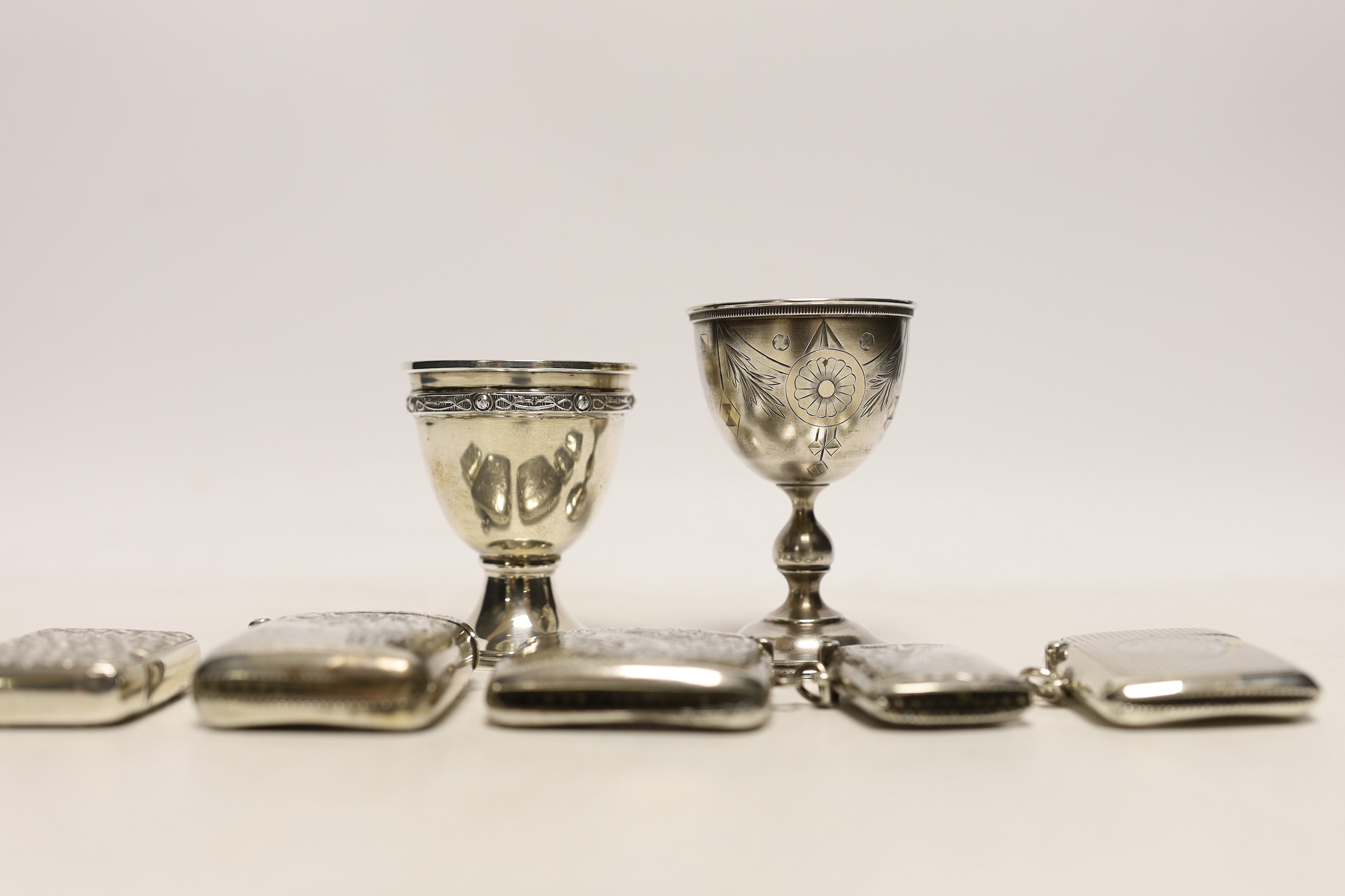 An early 20th century Russian 84 zolotnik egg cup, 69mm a later silver egg cup and five assorted silver vesta cases.